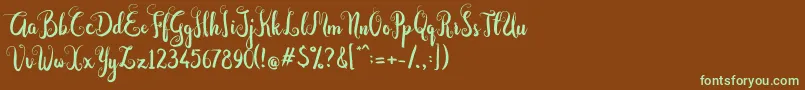 フォントDastan Script – 緑色の文字が茶色の背景にあります。