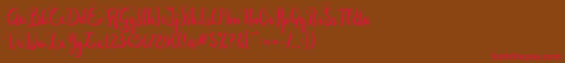 Czcionka Dastan Script – czerwone czcionki na brązowym tle