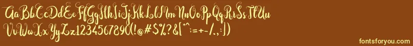 Dastan Script-fontti – keltaiset fontit ruskealla taustalla