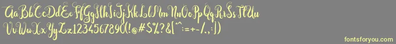 Dastan Script-fontti – keltaiset fontit harmaalla taustalla