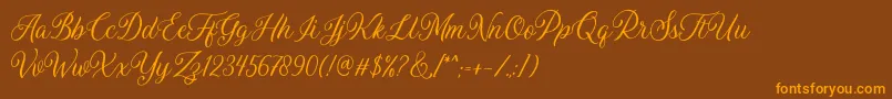 フォントDaytonia Free – オレンジ色の文字が茶色の背景にあります。