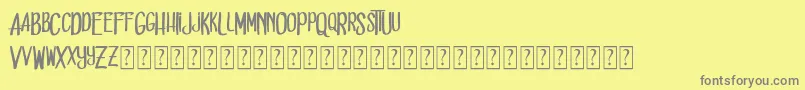 フォントDead solD – 黄色の背景に灰色の文字