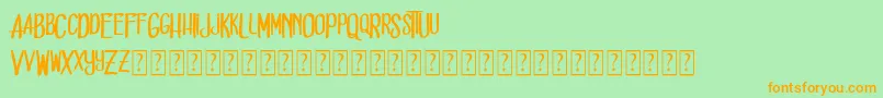 フォントDead solD – オレンジの文字が緑の背景にあります。