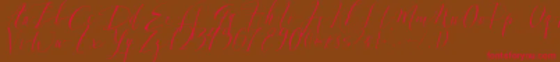 DearlyScript-fontti – punaiset fontit ruskealla taustalla