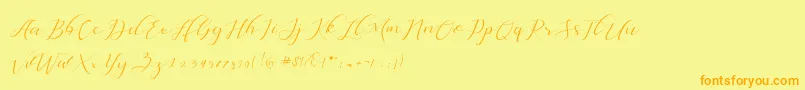 フォントDellisya – オレンジの文字が黄色の背景にあります。