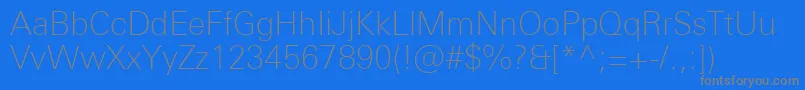 UniversNextProThin-Schriftart – Graue Schriften auf blauem Hintergrund
