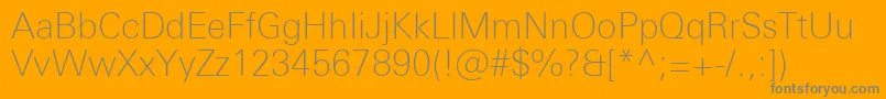 UniversNextProThin-Schriftart – Graue Schriften auf orangefarbenem Hintergrund