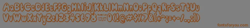 フォントComicWhiteRabbitDemo – 茶色の文字が灰色の背景にあります。