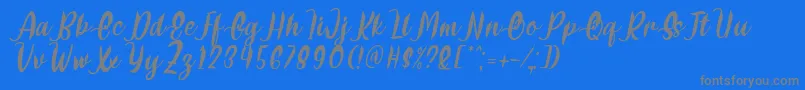 フォントDelumba Italic Font by 7NTypes – 青い背景に灰色の文字