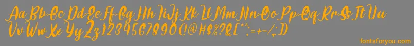 Delumba Italic Font by 7NTypes Font – Orange Fonts on Gray Background