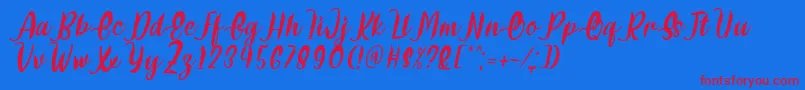 Delumba Italic Font by 7NTypes Font – Red Fonts on Blue Background