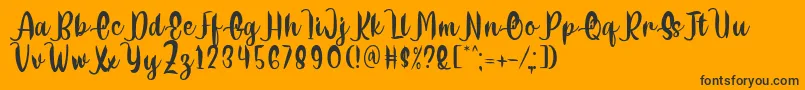 Delumba Regular Font by 7NTypes Font – Black Fonts on Orange Background