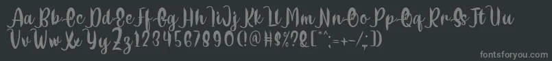 Delumba Regular Font by 7NTypes Font – Gray Fonts on Black Background