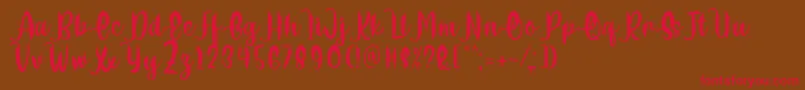 Delumba Regular Font by 7NTypes-Schriftart – Rote Schriften auf braunem Hintergrund