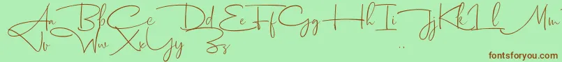 フォントDhanikans Signature 2 dafont – 緑の背景に茶色のフォント
