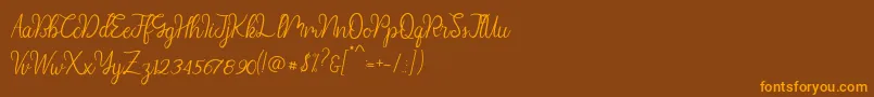 フォントDiana Script demo – オレンジ色の文字が茶色の背景にあります。