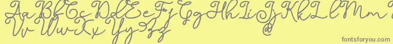 Dinila Script DAFONT-Schriftart – Graue Schriften auf gelbem Hintergrund