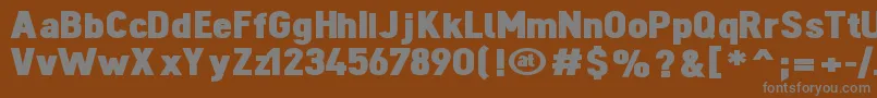 DINOBL  -fontti – harmaat kirjasimet ruskealla taustalla