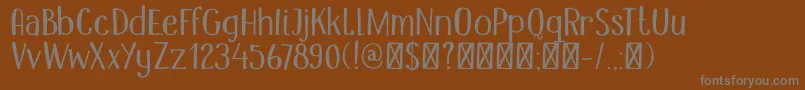 DK Mandolin-fontti – harmaat kirjasimet ruskealla taustalla