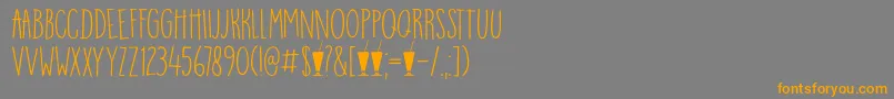 DK Mango Smoothie-Schriftart – Orangefarbene Schriften auf grauem Hintergrund