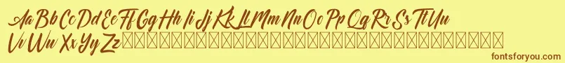 フォントDominick – 茶色の文字が黄色の背景にあります。