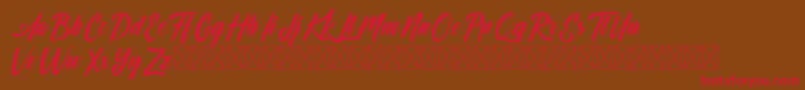 Czcionka Dominick – czerwone czcionki na brązowym tle