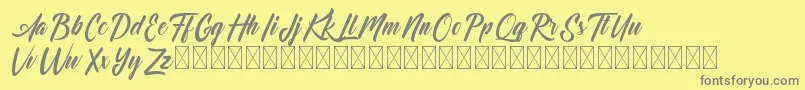 Dominick-fontti – harmaat kirjasimet keltaisella taustalla