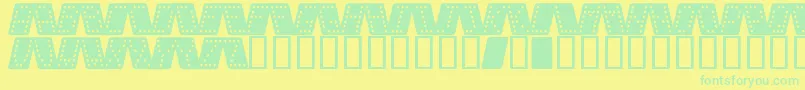 Domino k Font – Green Fonts on Yellow Background