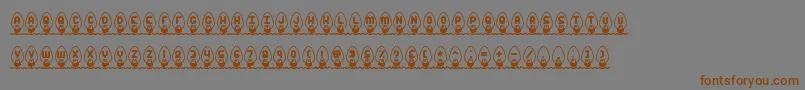 フォントXmasLightsBrk – 茶色の文字が灰色の背景にあります。