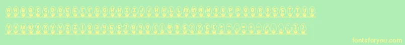 フォントXmasLightsBrk – 黄色の文字が緑の背景にあります