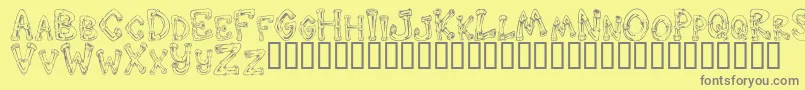 DOWND   -fontti – harmaat kirjasimet keltaisella taustalla