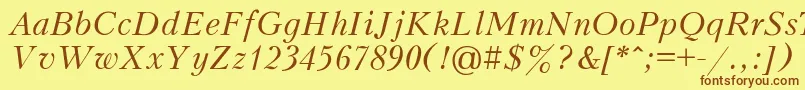 フォントPeterburgItalic – 茶色の文字が黄色の背景にあります。