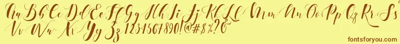 フォントEctomorph Dafont – 茶色の文字が黄色の背景にあります。