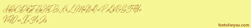 フォントelaineighteen – 茶色の文字が黄色の背景にあります。