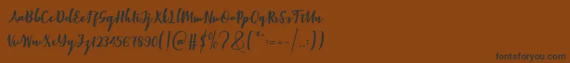 Elistabeta-Schriftart – Schwarze Schriften auf braunem Hintergrund