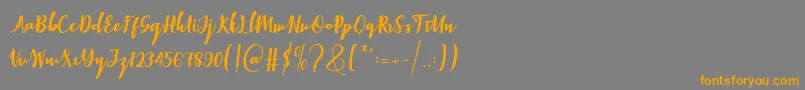 フォントElistabeta – オレンジの文字は灰色の背景にあります。