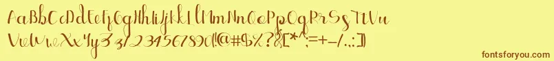 フォントEllic Script 1 – 茶色の文字が黄色の背景にあります。