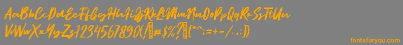 フォントEmatodas Demo – オレンジの文字は灰色の背景にあります。