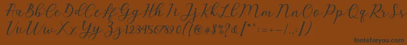fuente Emeley Script – Fuentes Negras Sobre Fondo Marrón