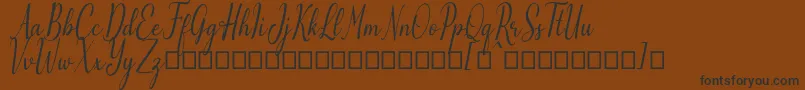 Emilyne Demo Font – Black Fonts on Brown Background
