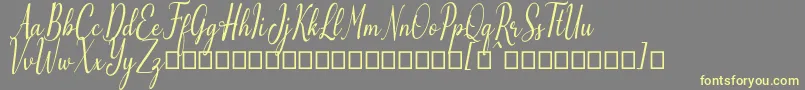 Шрифт Emilyne Demo – жёлтые шрифты на сером фоне