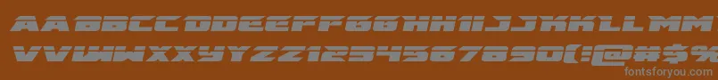 Fonte emissarylaserital – fontes cinzas em um fundo marrom