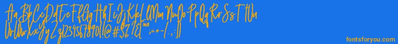 フォントEmma signature – オレンジ色の文字が青い背景にあります。