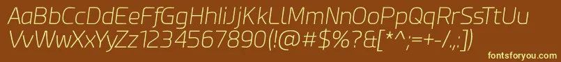 Esphimere Extra Light Italic-fontti – keltaiset fontit ruskealla taustalla