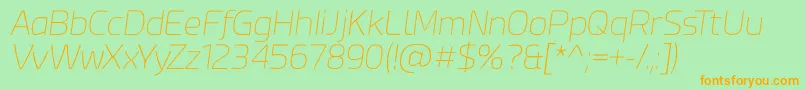 Esphimere Thin Italic-Schriftart – Orangefarbene Schriften auf grünem Hintergrund