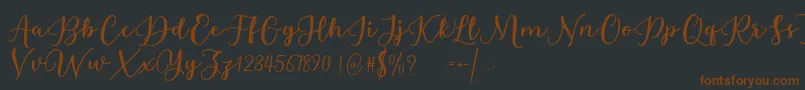 フォントEstafet Letter Script – 黒い背景に茶色のフォント