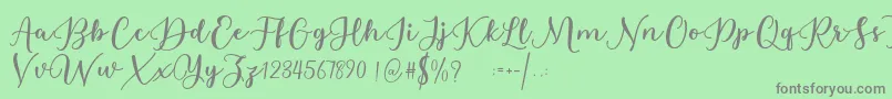 フォントEstafet Letter Script – 緑の背景に灰色の文字