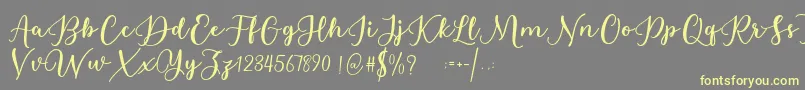 Estafet Letter Script Font – Yellow Fonts on Gray Background