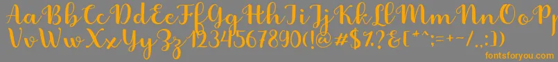 Fabitha Script-Schriftart – Orangefarbene Schriften auf grauem Hintergrund