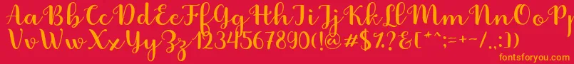 フォントFabitha Script – 赤い背景にオレンジの文字